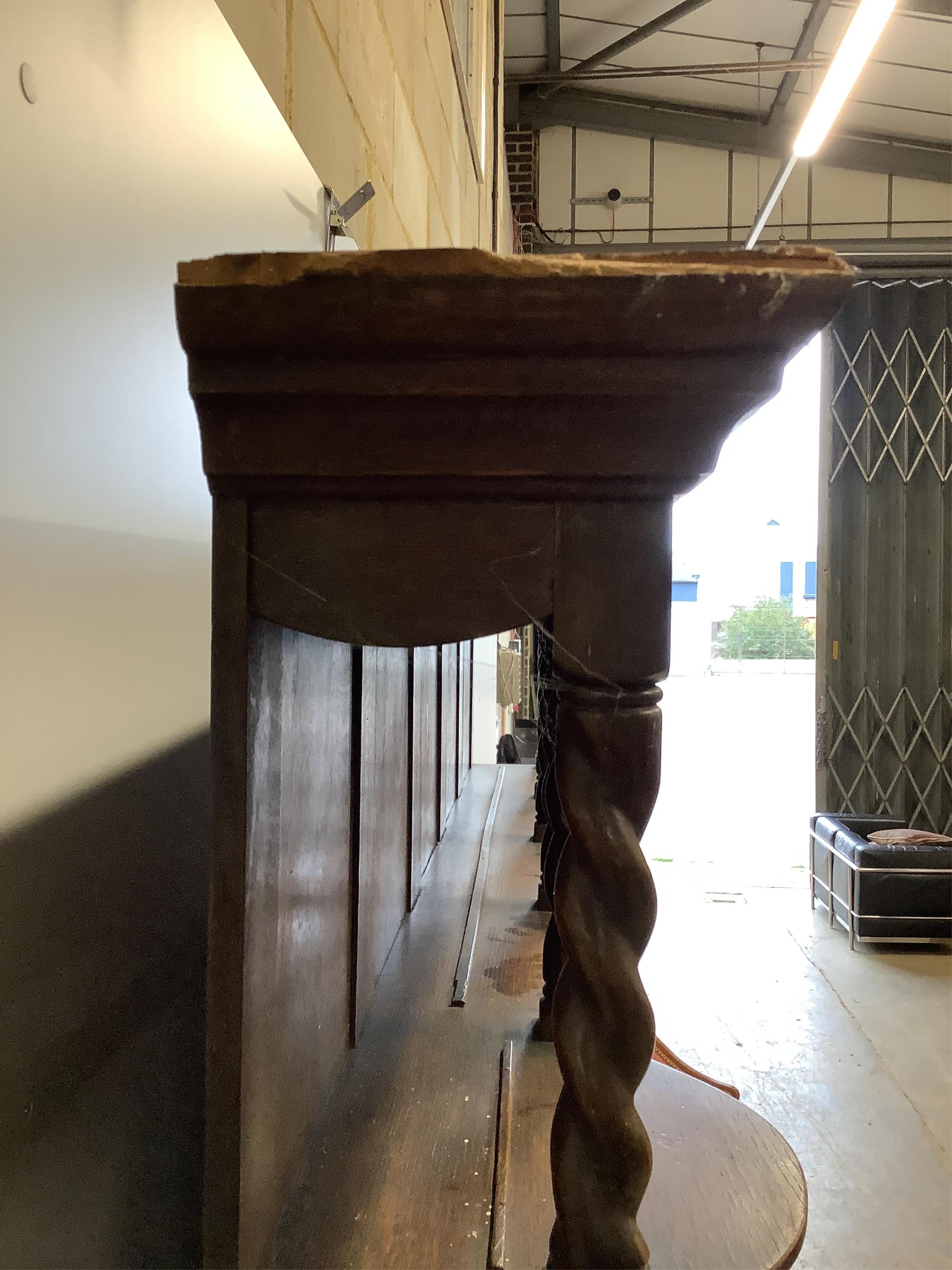 An early 20th century Liberty style oak dresser, width 157cm, height 208cm. Condition - damage to the top left of the cornice otherwise looks to be in good order